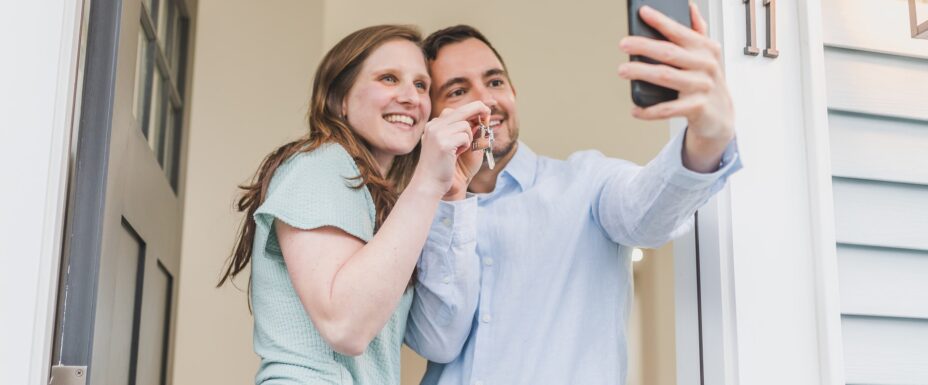 Couple Having Selfie while Holding Keys of their new home