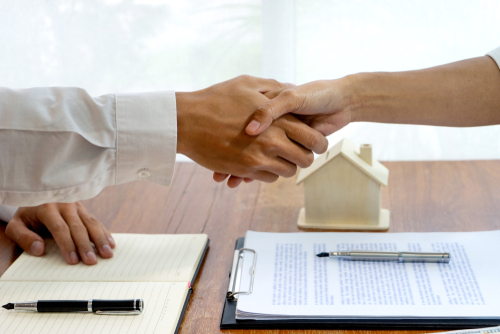 handshake with customer after house purchase contract 